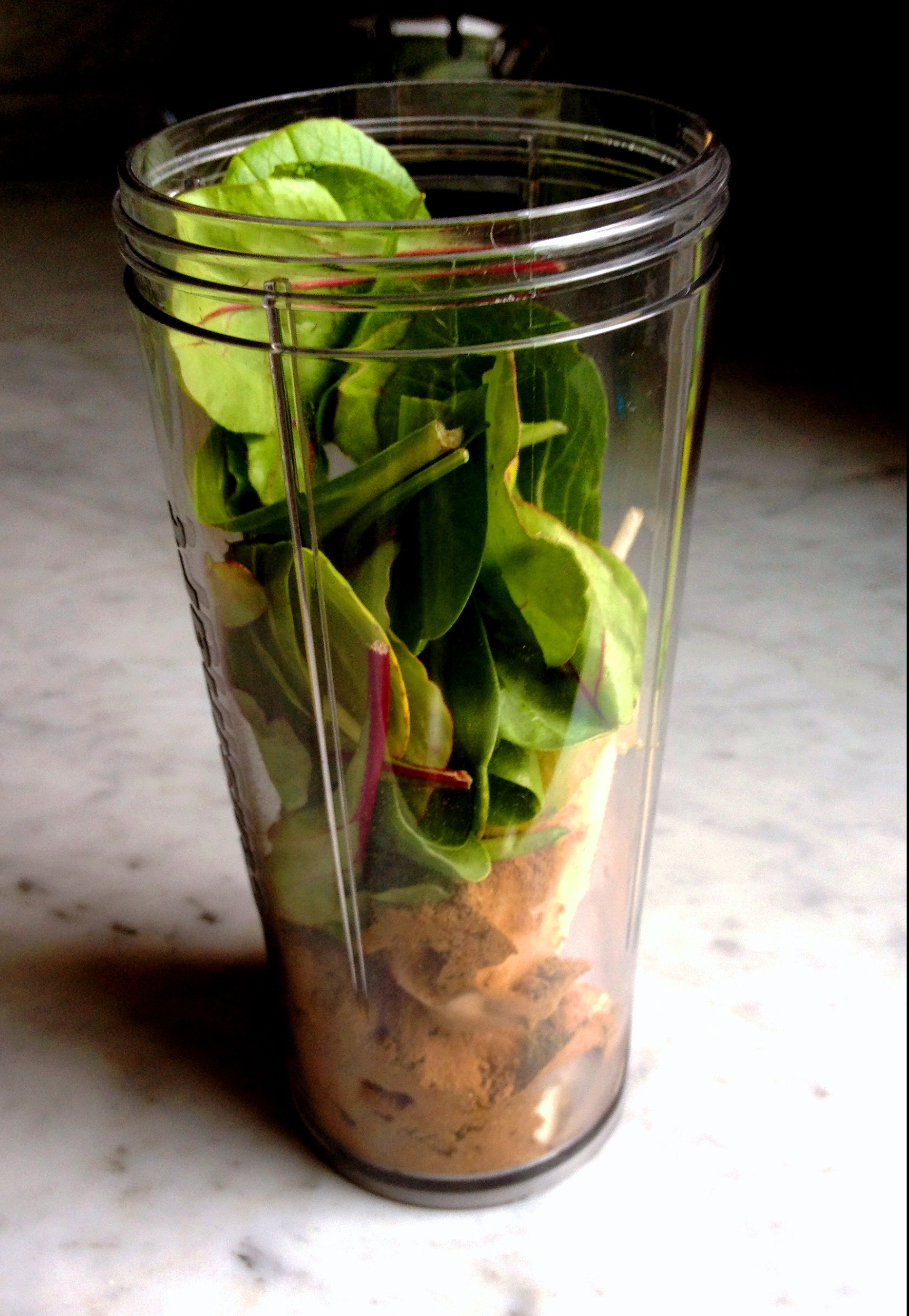 spinach added to smoothie cup