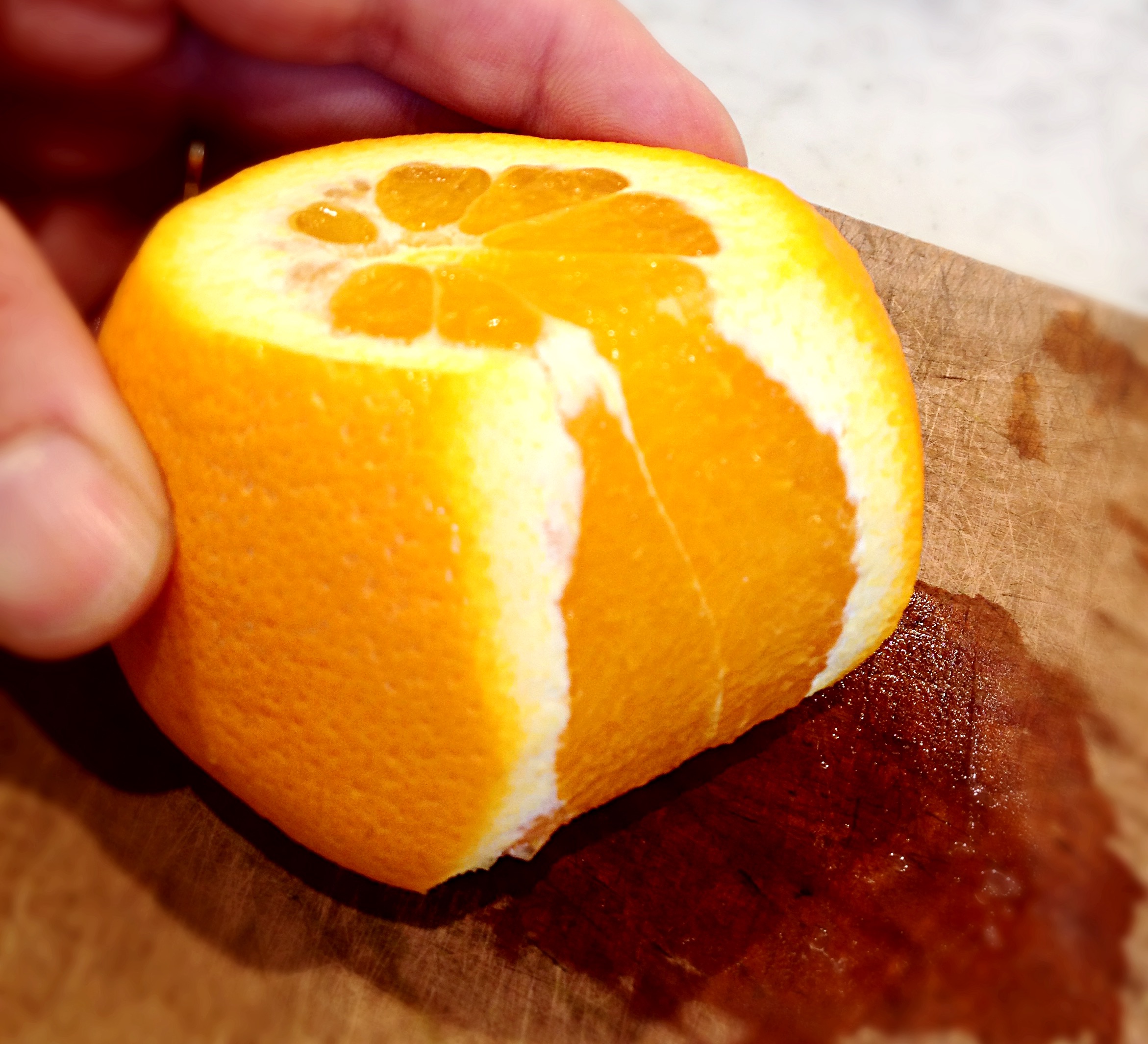 Trimming the peel and pith off the orange
