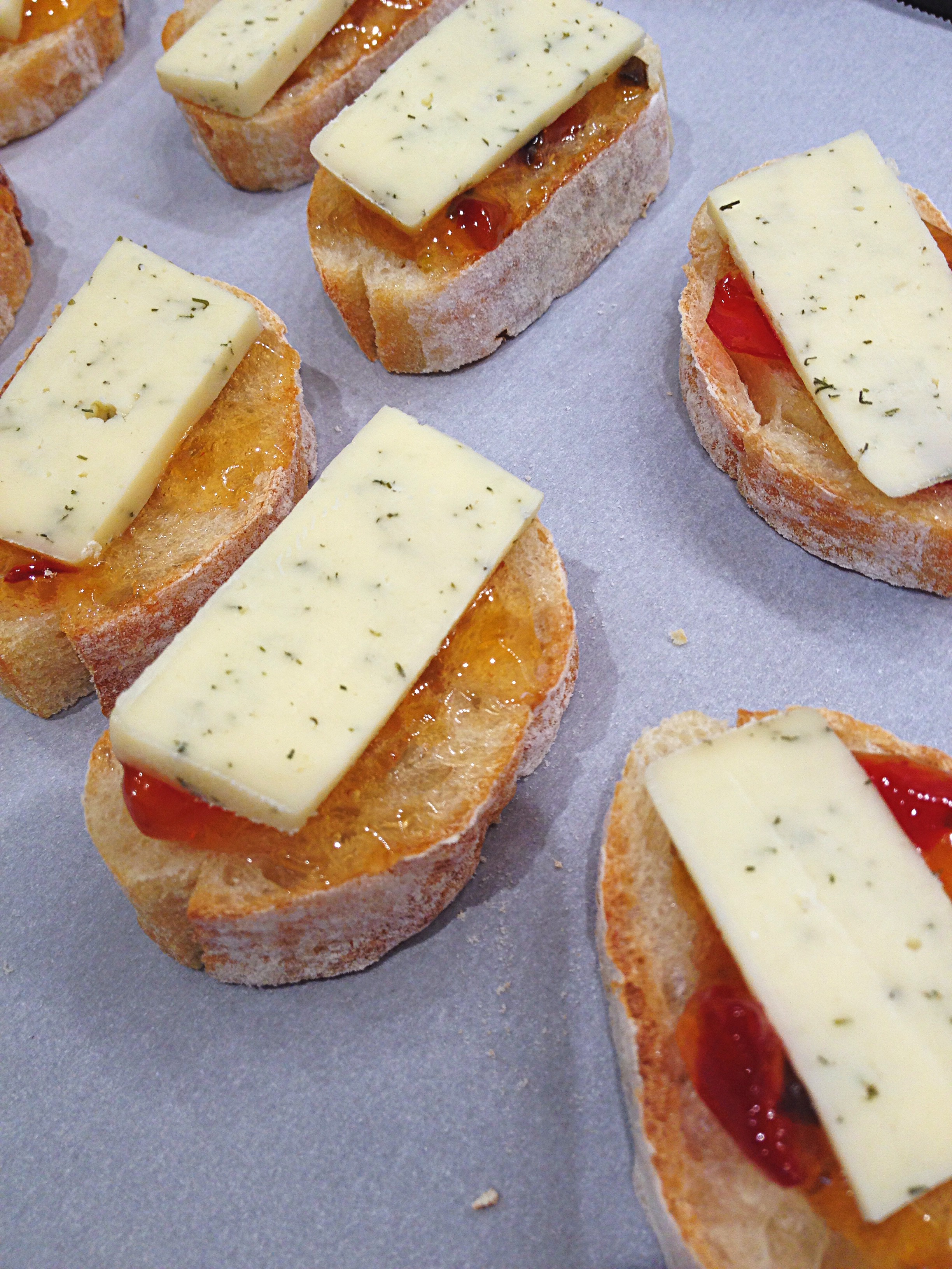 Havarti cheese is put over the jelly on the baguette