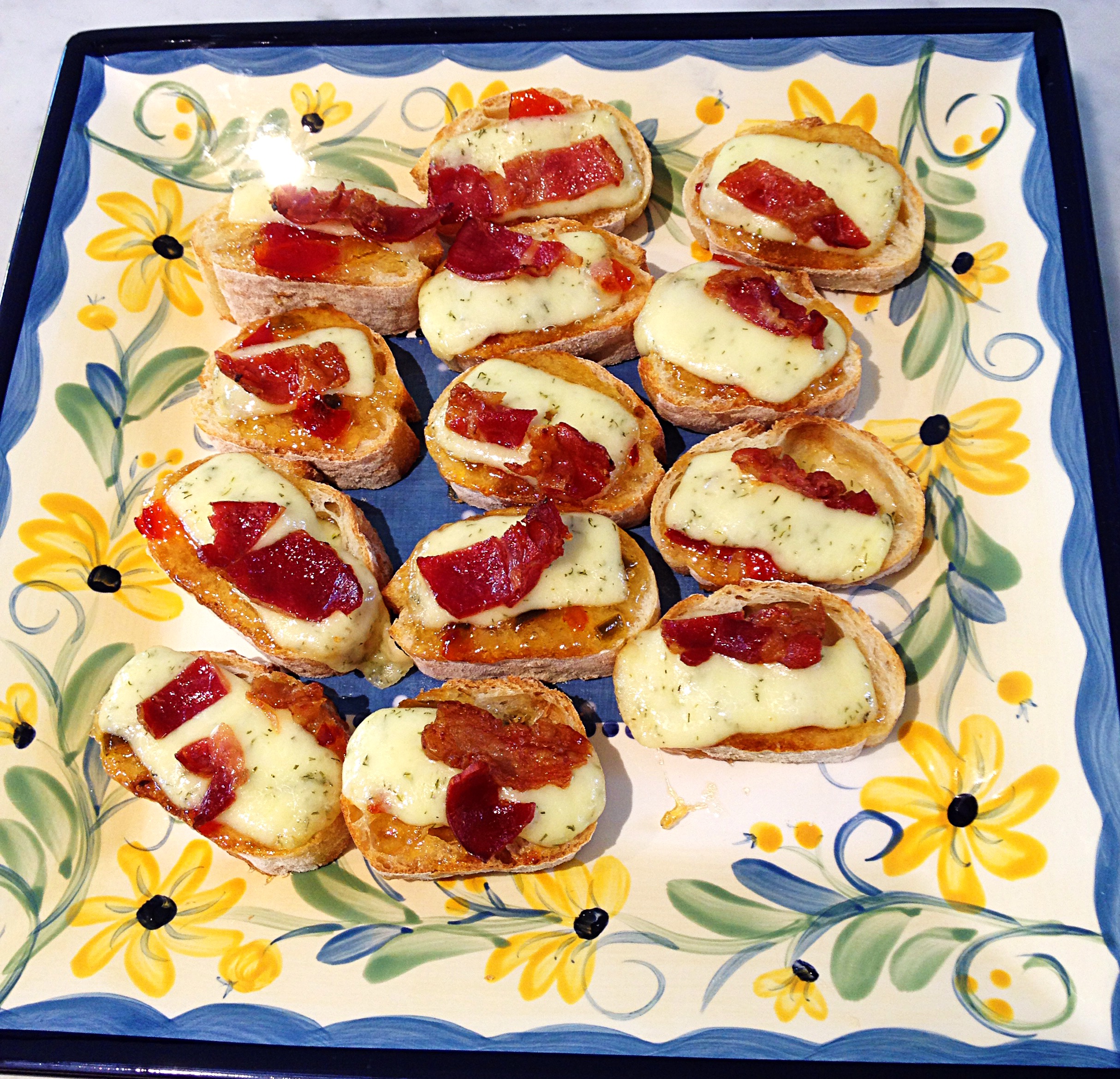 baguette rounds topped with pepper jelly, Havarti cheese, and bacon crumbles.
