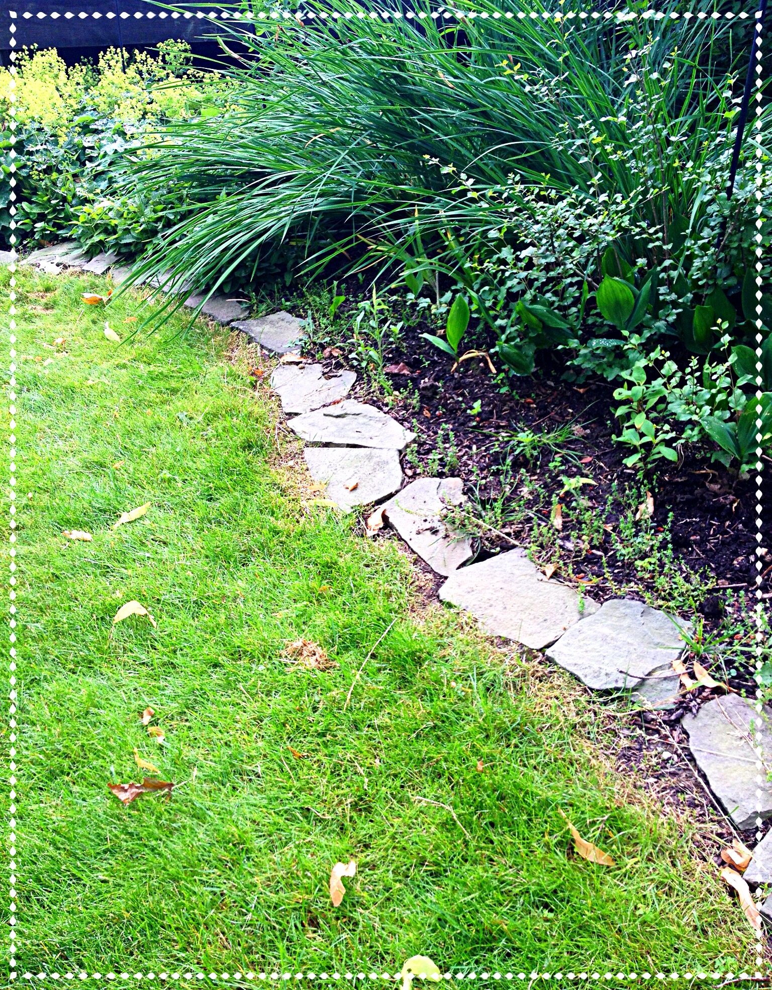 Stone is used as edging around this flower border