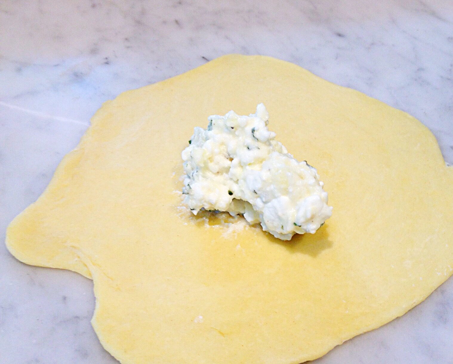 Photo of rolled out dough with filling placed on top