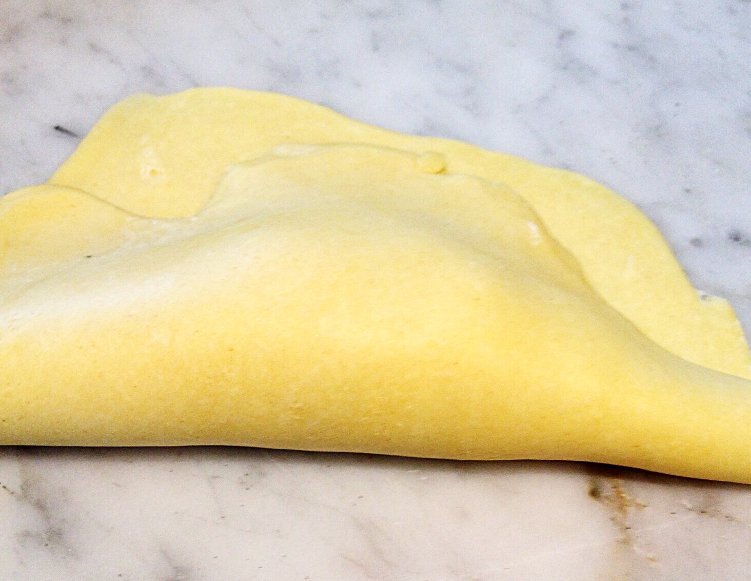 Photo showing folding dough over the filling.