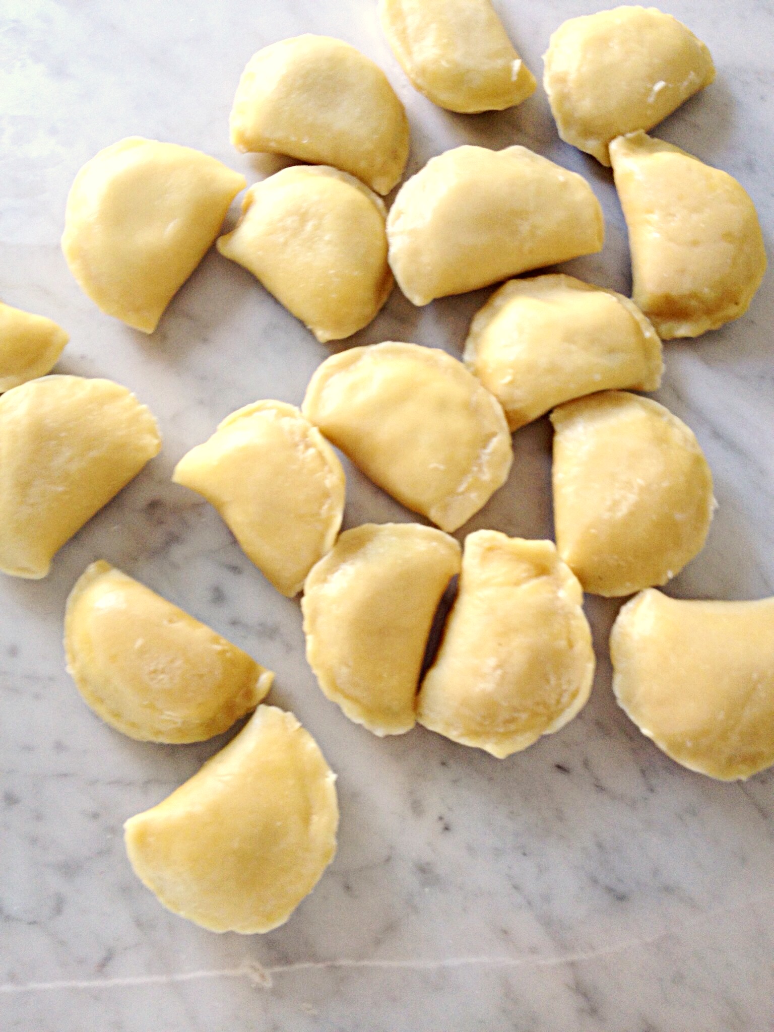 Photo showing boiled pierogi drying on countertop