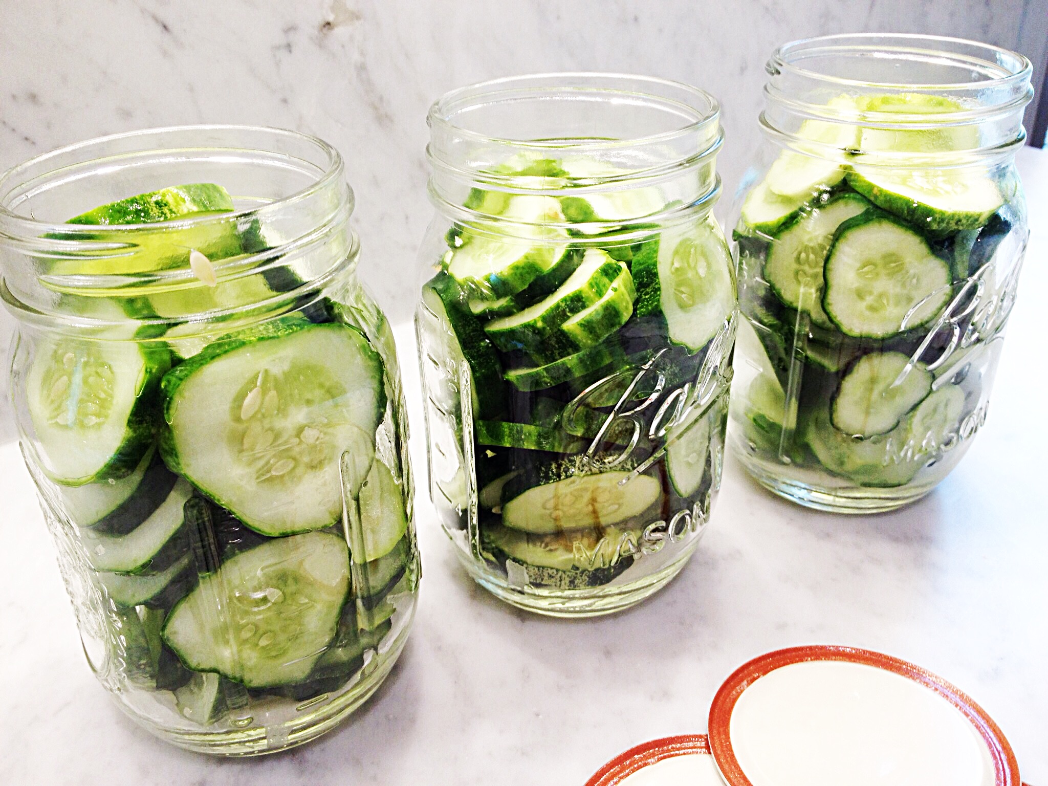 Photo of cucumber slices packed into pint jars