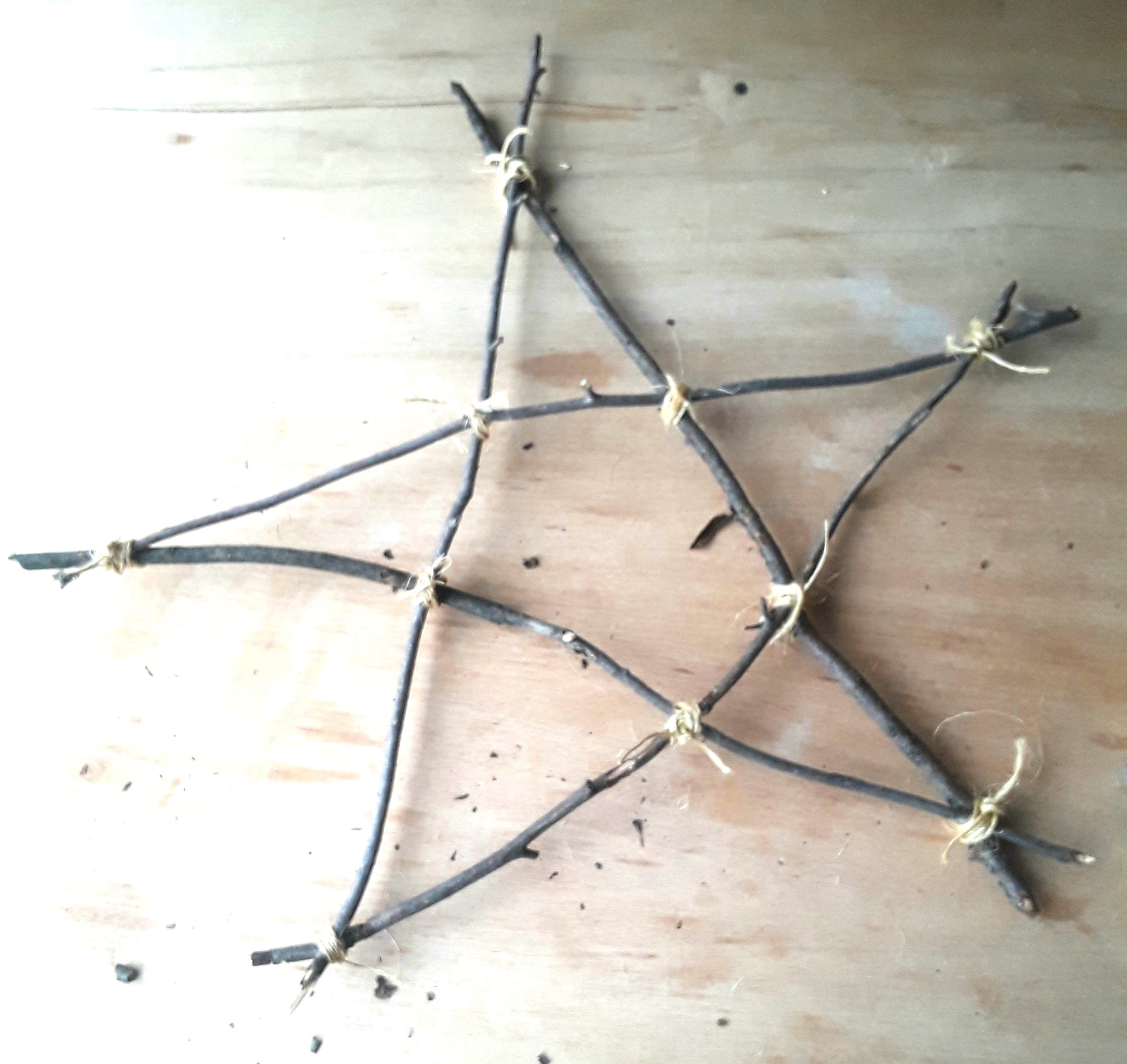 Star made from tree branches tied with twine