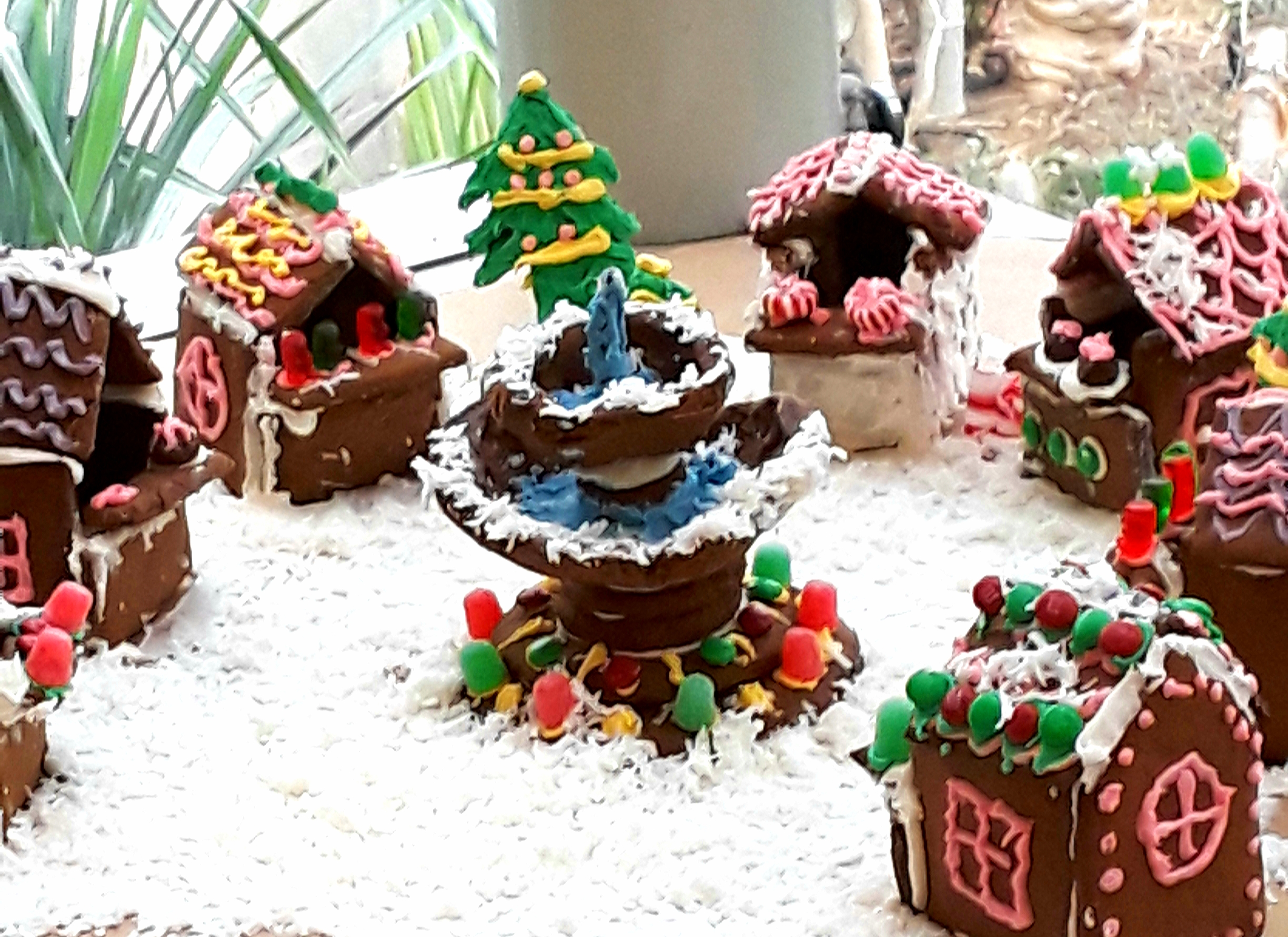 Gingerbread cottages surround a fountain made from cookies, frosting, and gumdrops