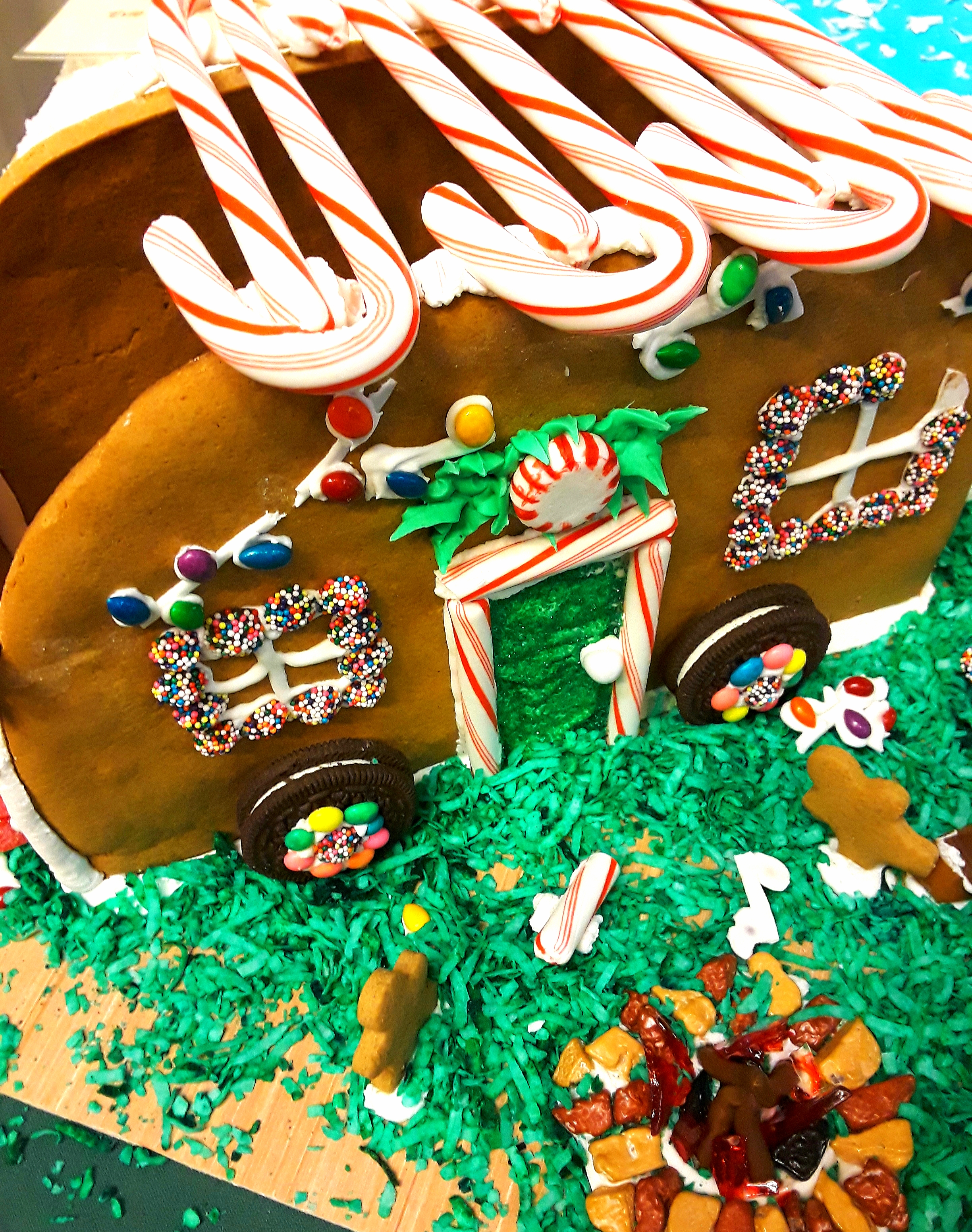 The camper is decorated with candy canes and sandwich cookie wheels