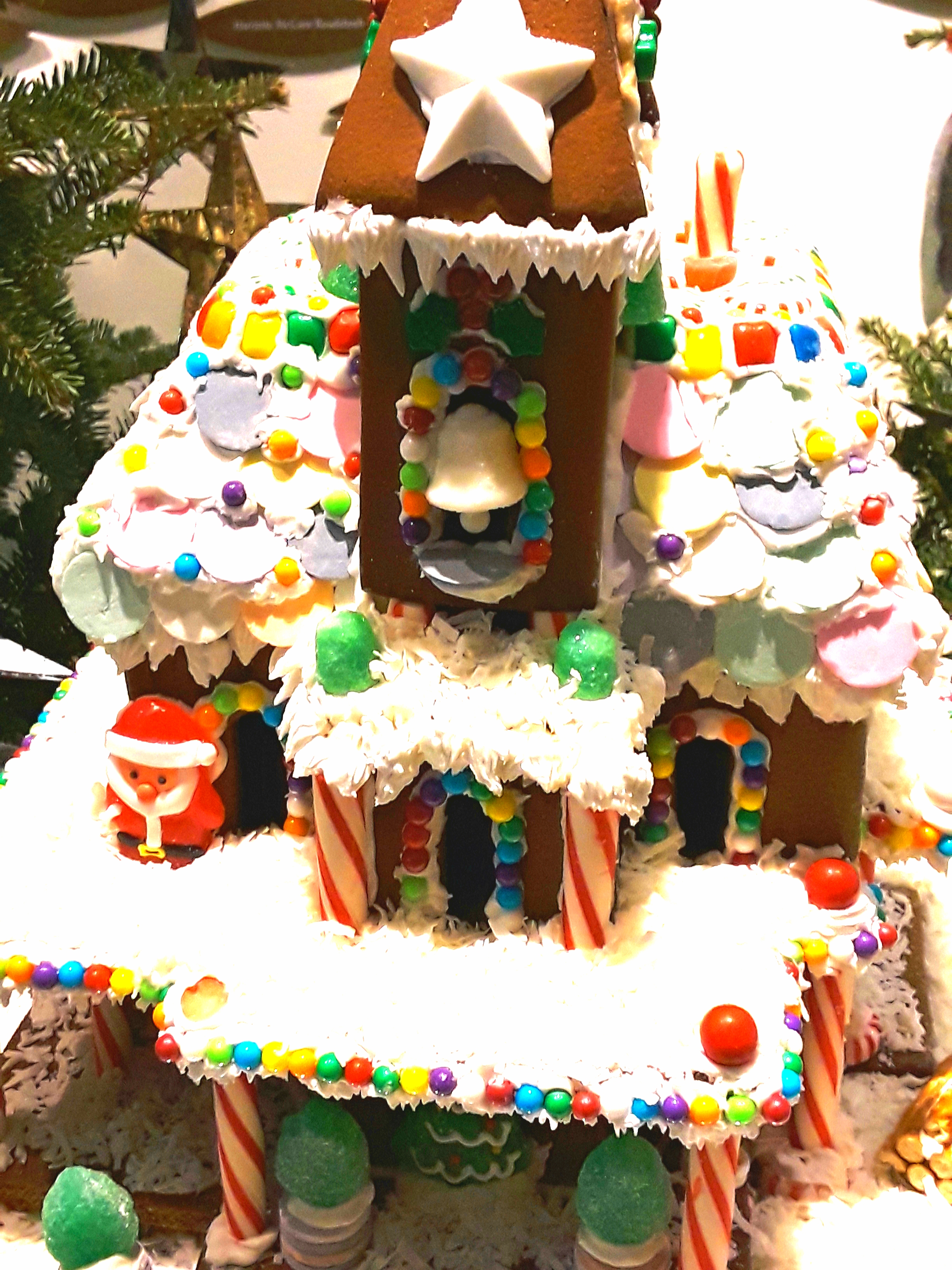Three story gingerbread house with coconut snow on the roof