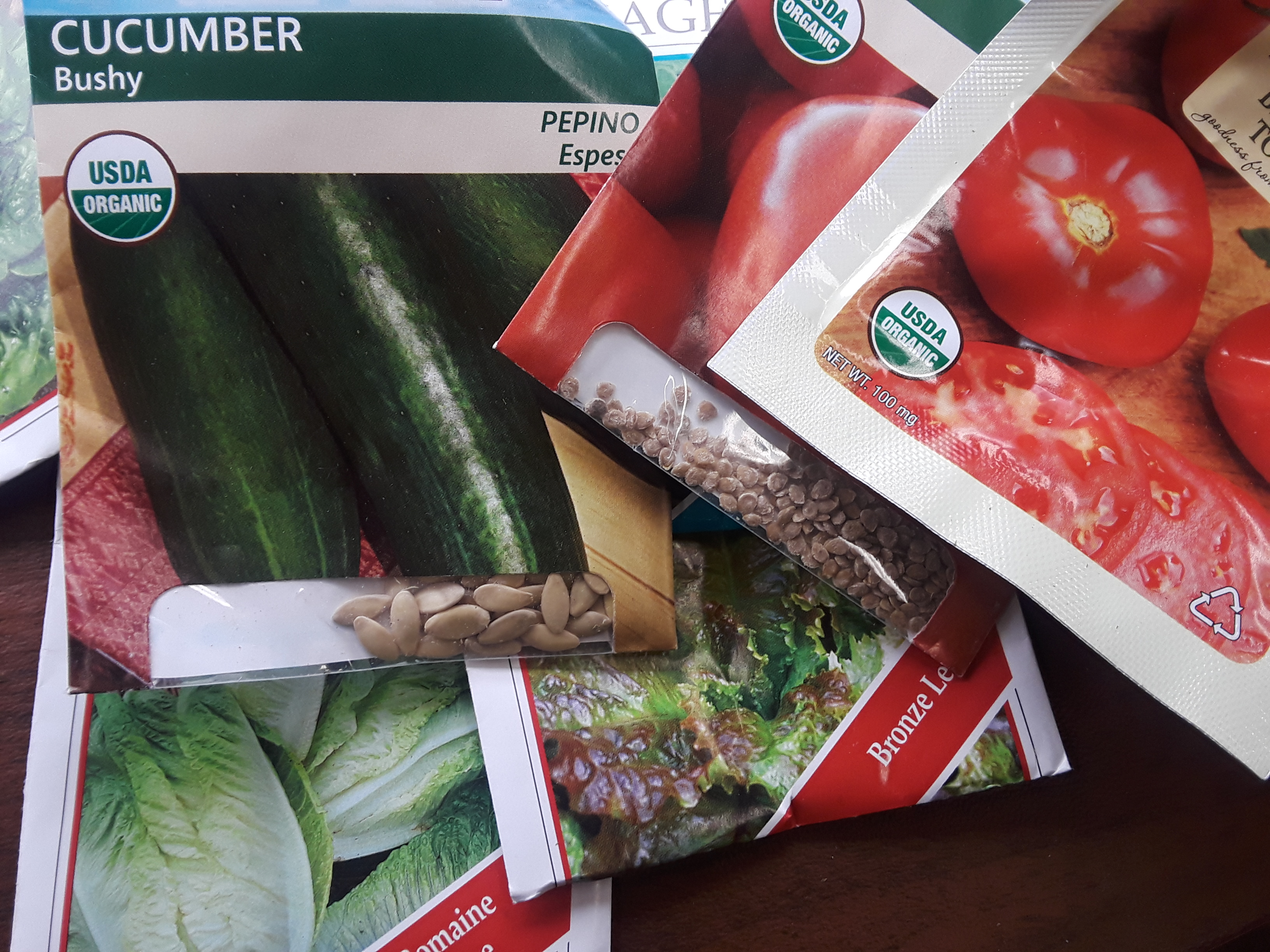 seed packets of tomatoes, cucumber, and lettuce