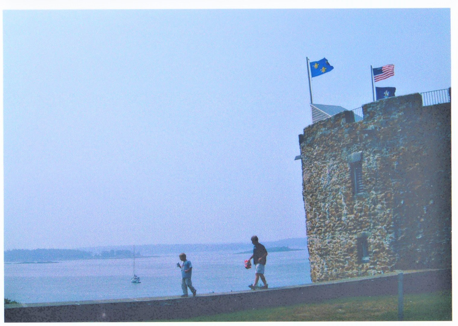 Father and son walk along the wall outside of the reconstructed Fort William Henry