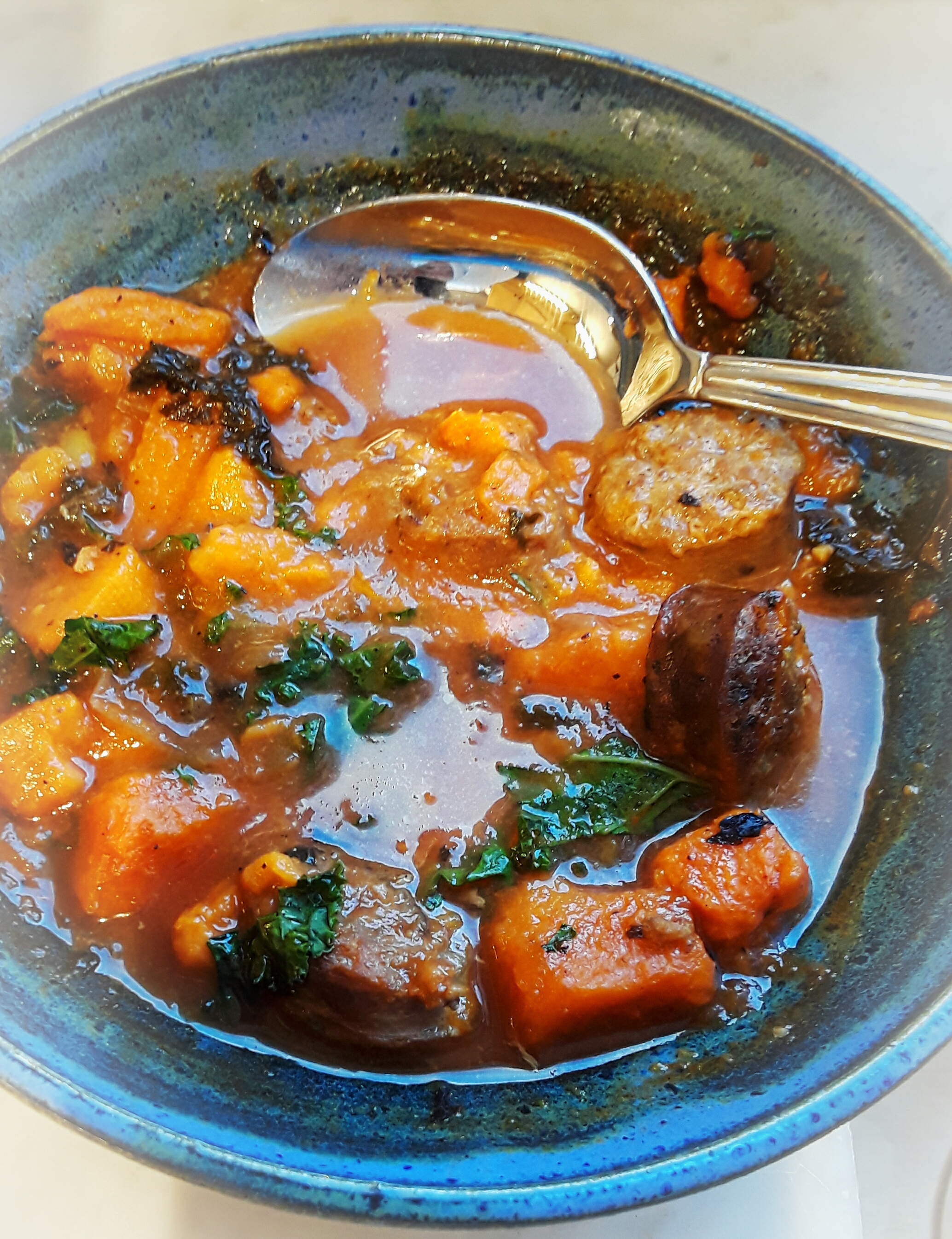 chorizo stew in blue bowl