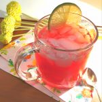 Mug of pomegranate fizz with lime slice