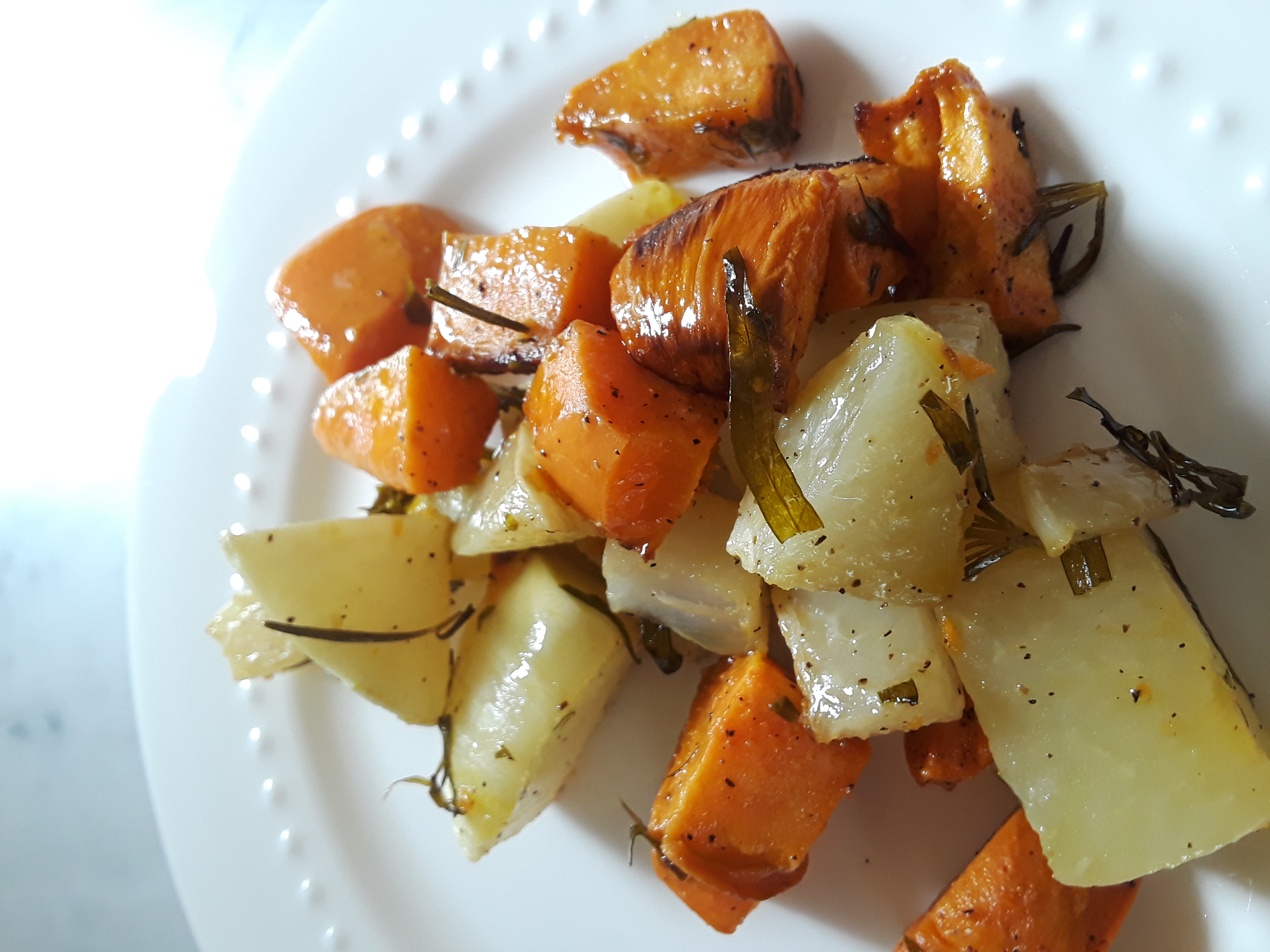 Cubes of kohlrabi and sweet potato are baked with rosemary and tarragon