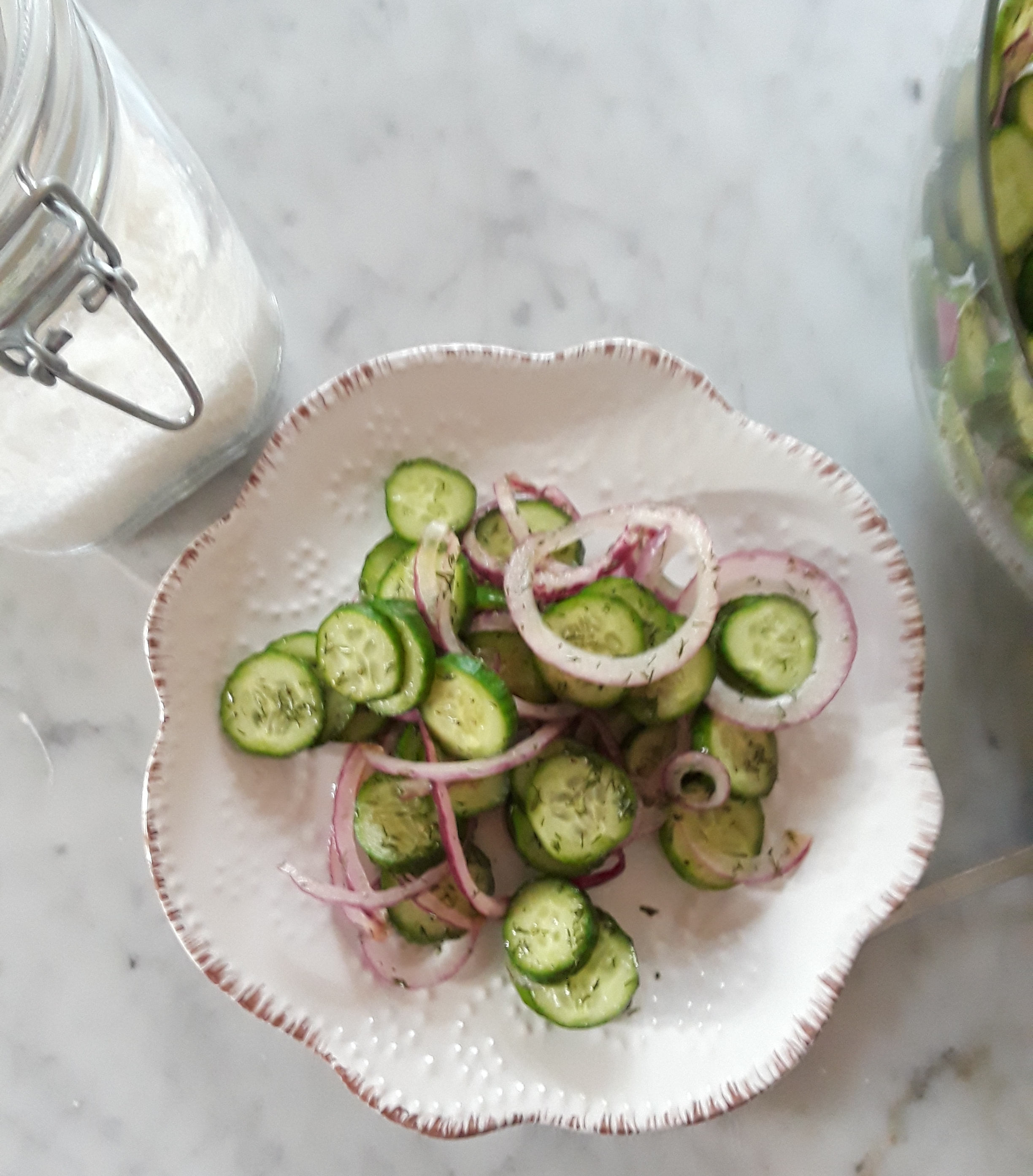 photo of sliced cucumbers and onions with spices and dressing