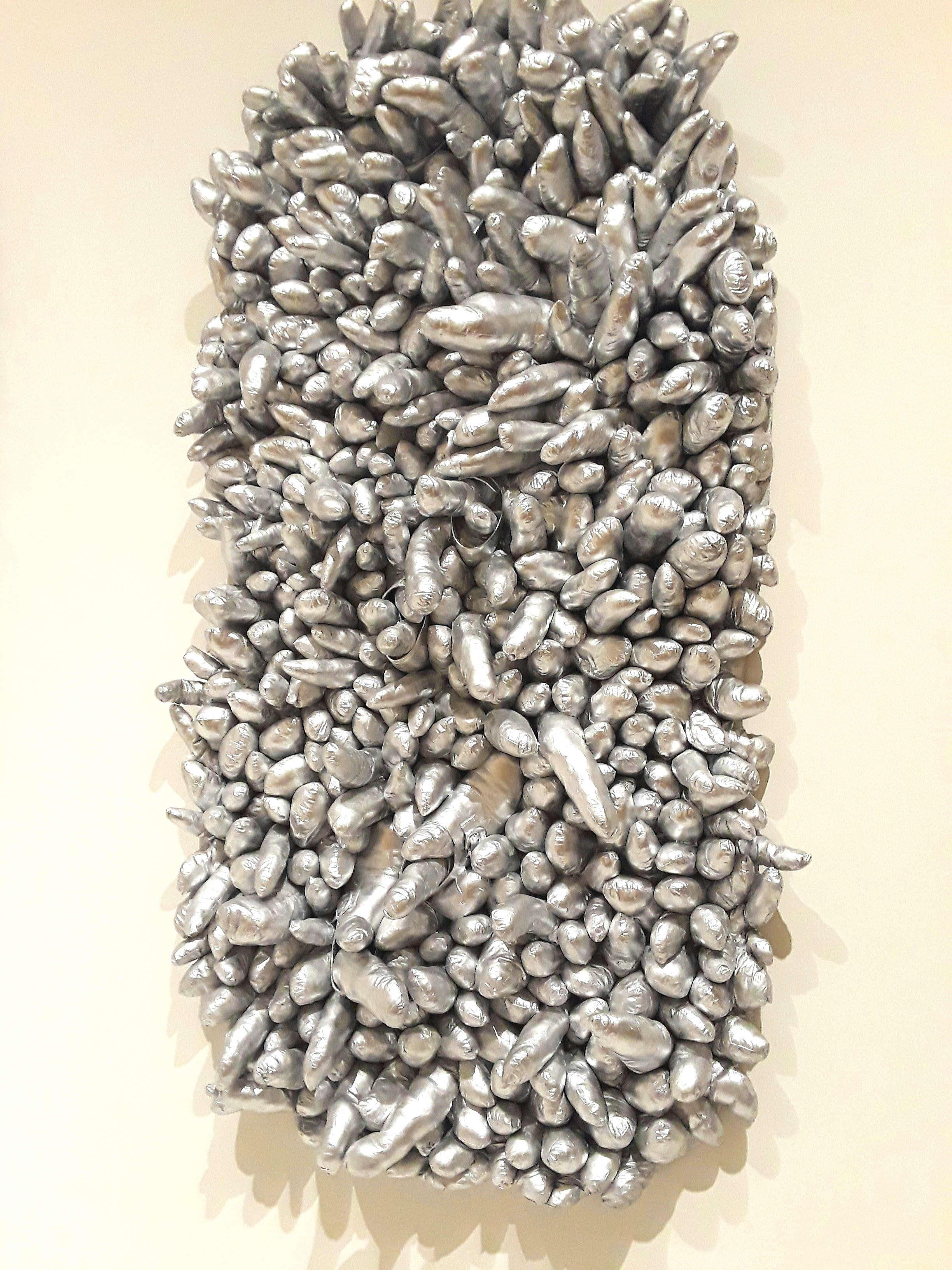 the phallus theme in silver metallic sculpture