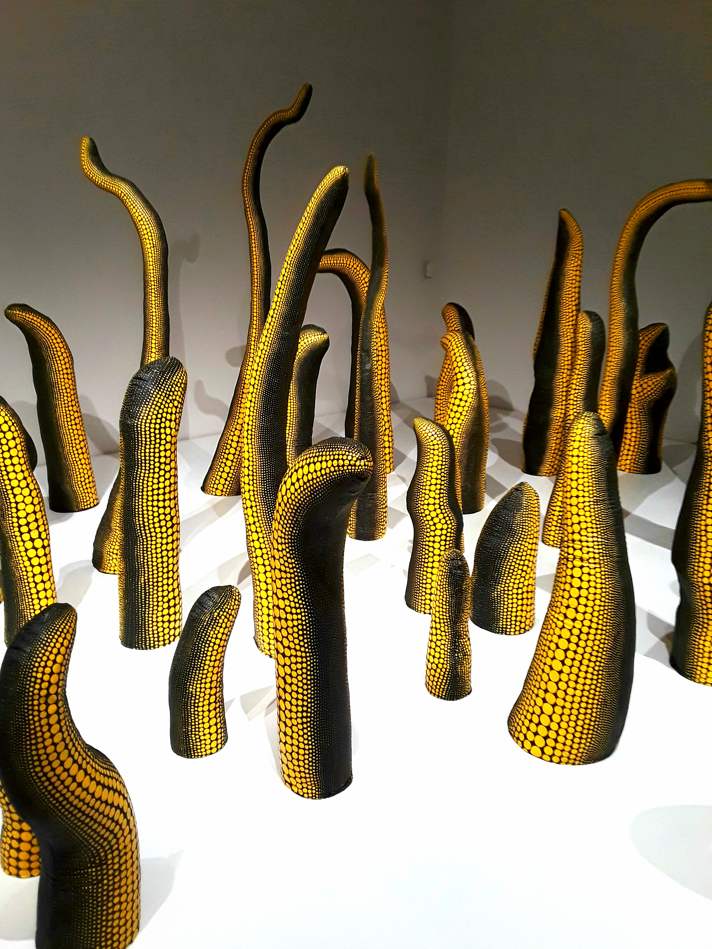 yellow and black sculptures resemble octopus tentacles