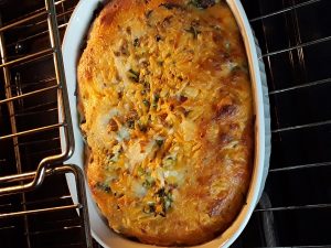 the baked casserole is golden brown and puffy