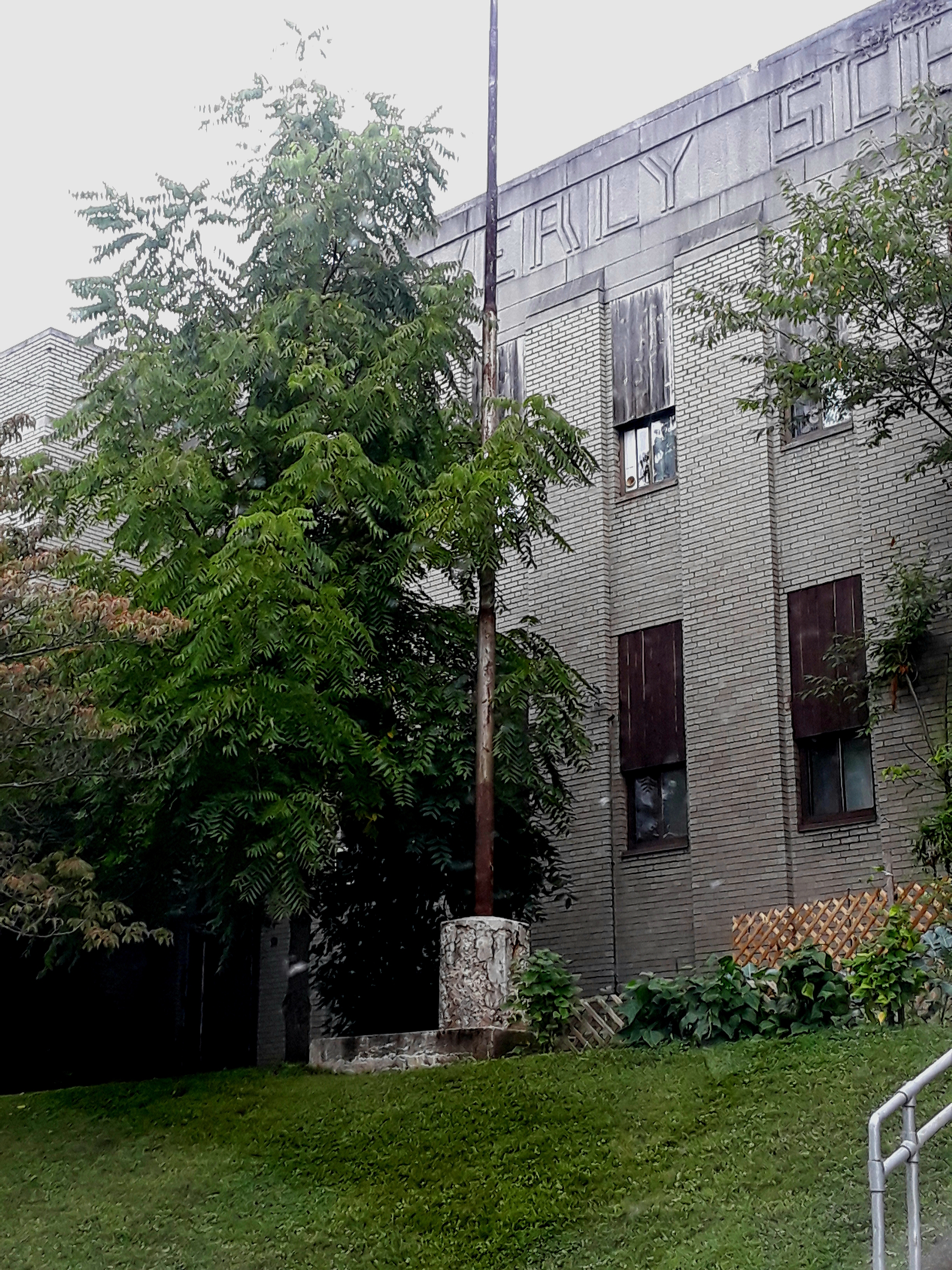 The old school building is made from off-white brick, and reflects an art-deco inspired architecture