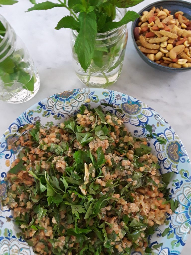 serving bowl with blue paisley pattern heaping with lentil salad made with herbs