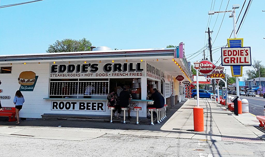 Hamburger and root beer stand with bar stool seating.