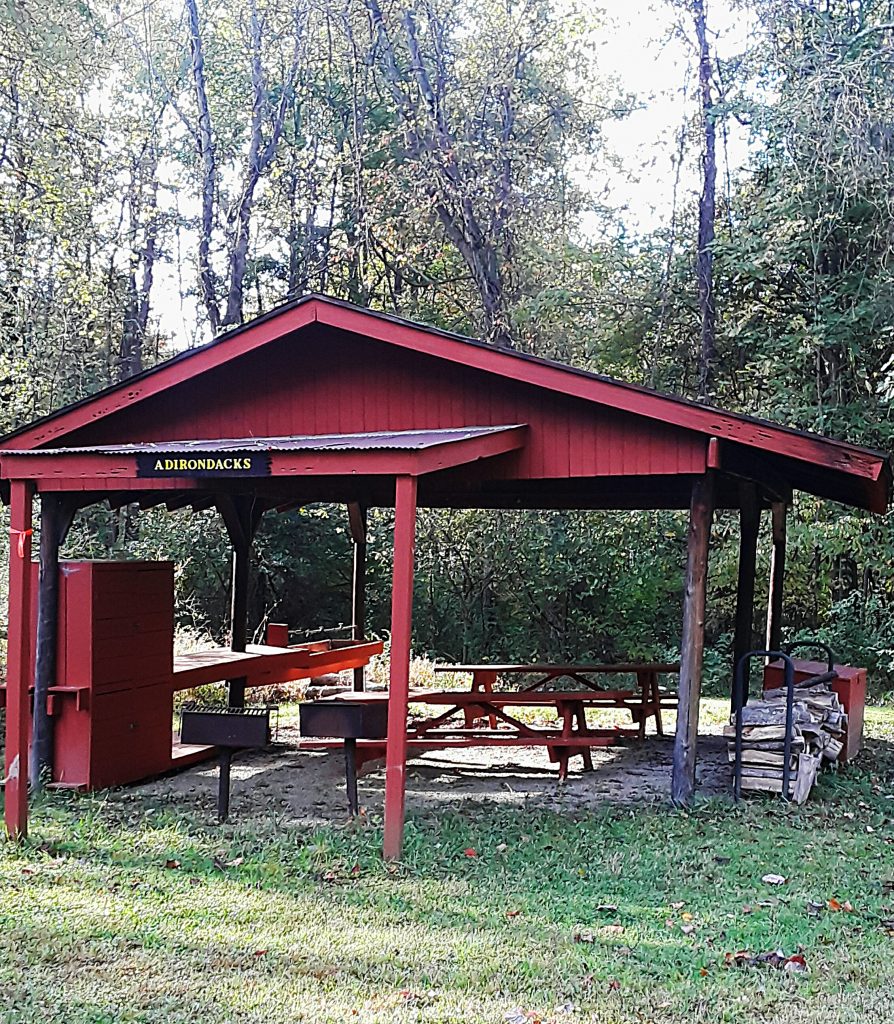 A picnic shelter along the trail covers two tables and two grills