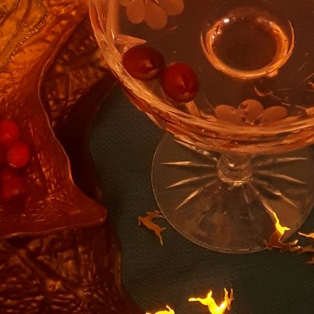 pomegranate champagne cocktails with floating cranberries