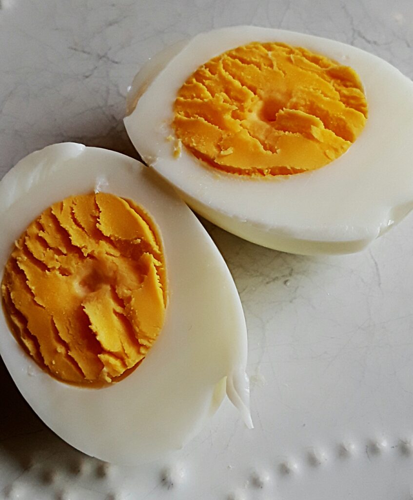 halved hard-boiled eggs show a rich yellow yolk