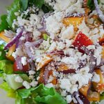 crumbled feta tops the fresh peach and corn