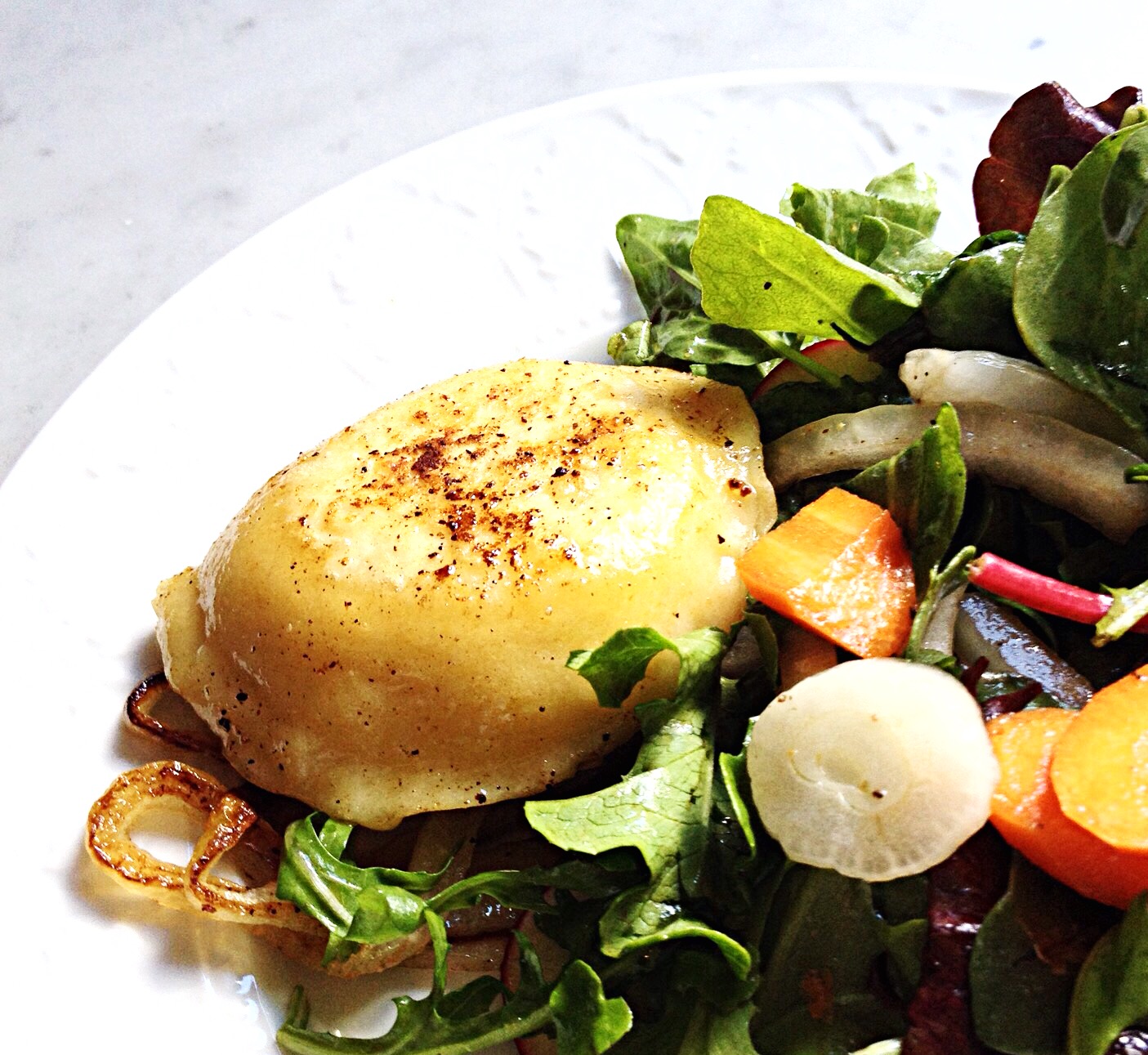 Photo of Cheese and Potato Pierogi with a side salad.