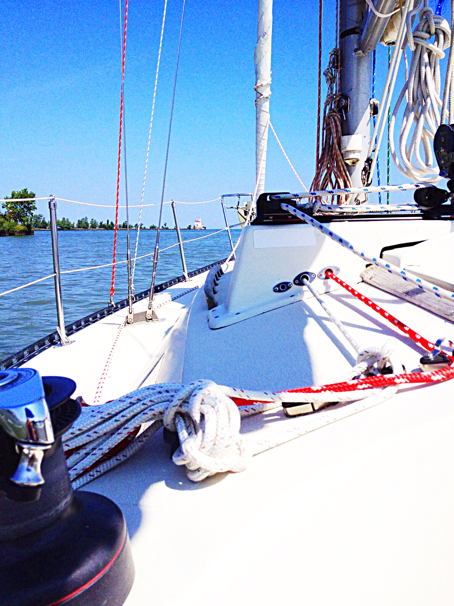photo of sailboat heading out to sea