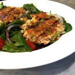 Salmon cakes served with baby greens and a simple vinaigrette
