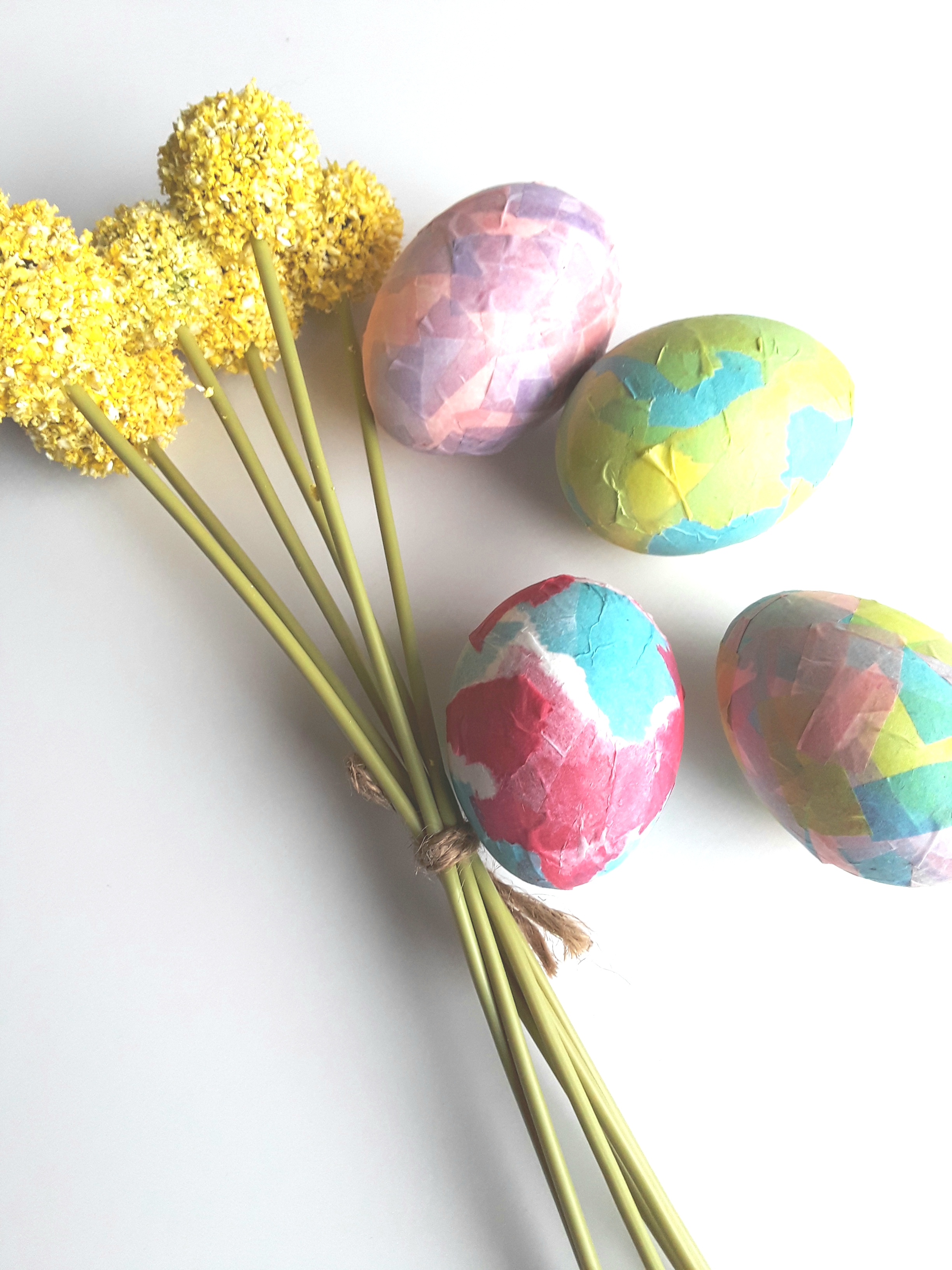 Blown-out eggs are coated with colored bits of tissue paper