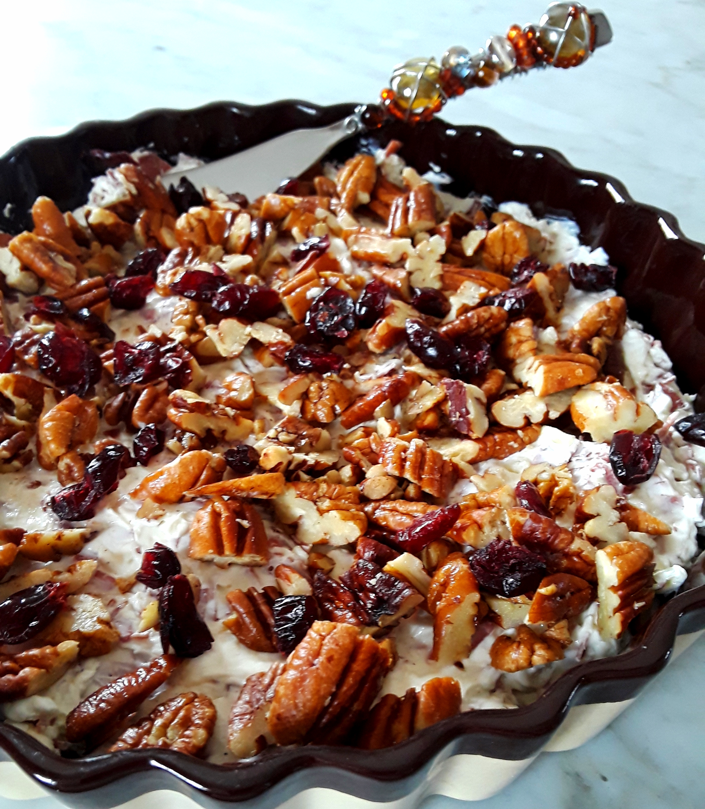 toasted pecans and dried cranberries top cream cheese beef dip