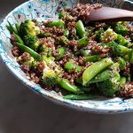 Snap peas and broccoli mixed into cooked red quinoa.