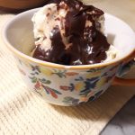 warm chocolate fudge sauce poured over vanilla ice ccream