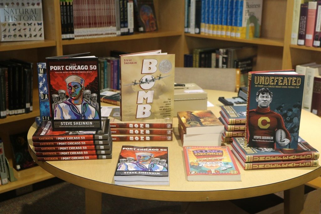 Display of new books ob maple table in the bookstore