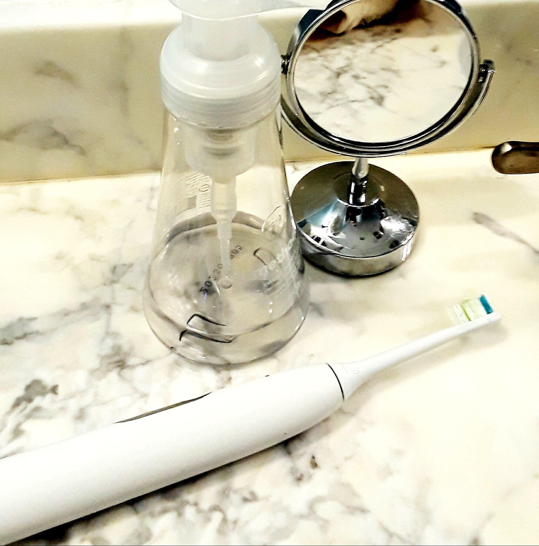 Soniccare toothbrush is all white and unobtrusive on the bathroom counter