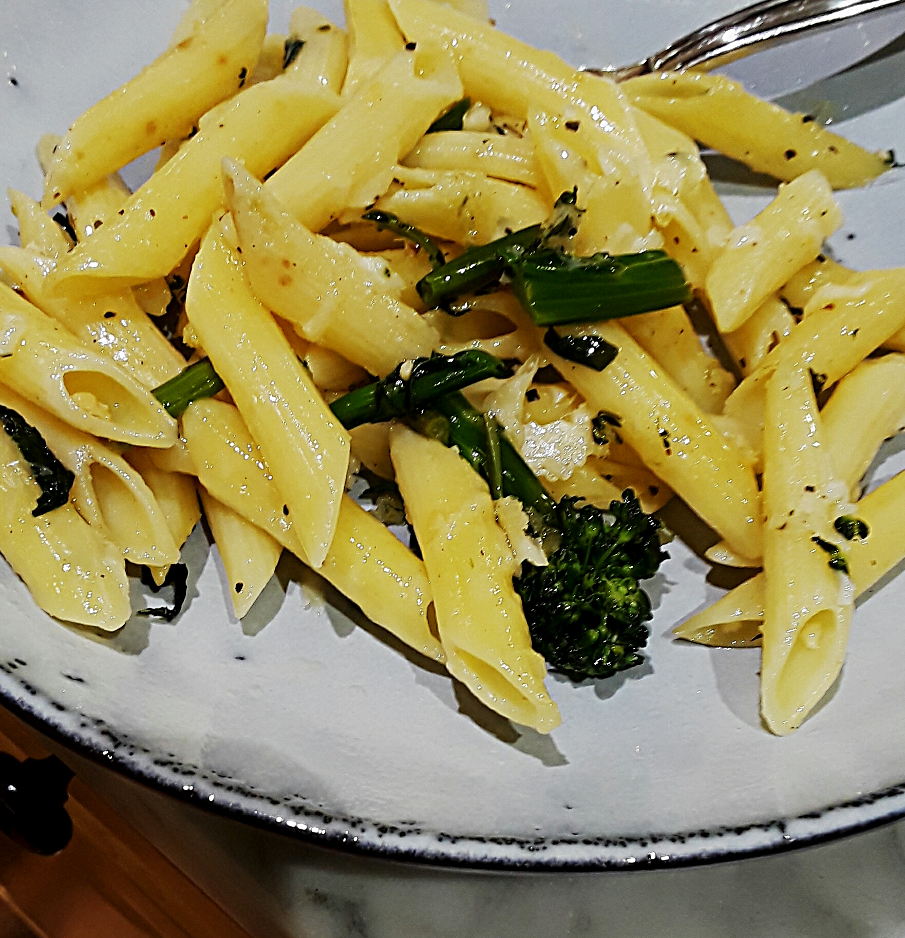 penne pasta served with chopped broccolini