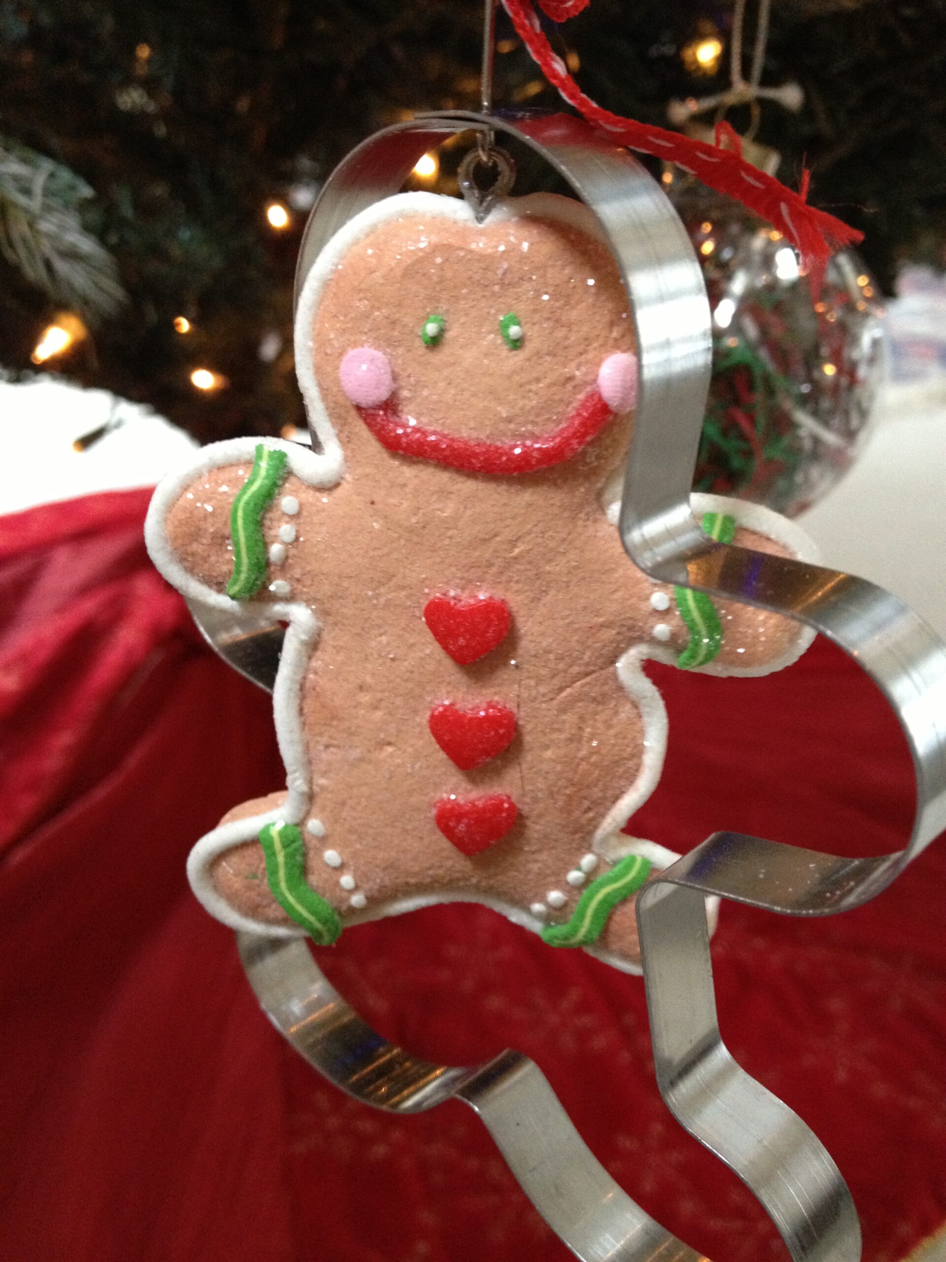 A gingerbread man ornament appears to be running away from the cookie cutter